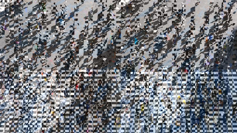 Flygfoto över många människor som går över ett övergångsställe.